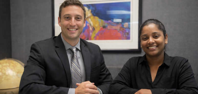 Greg Lipsit, owner of TaxGlad sitting next to woman in office
