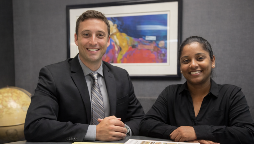 Greg Lipsit, owner of TaxGlad sitting next to woman in office
